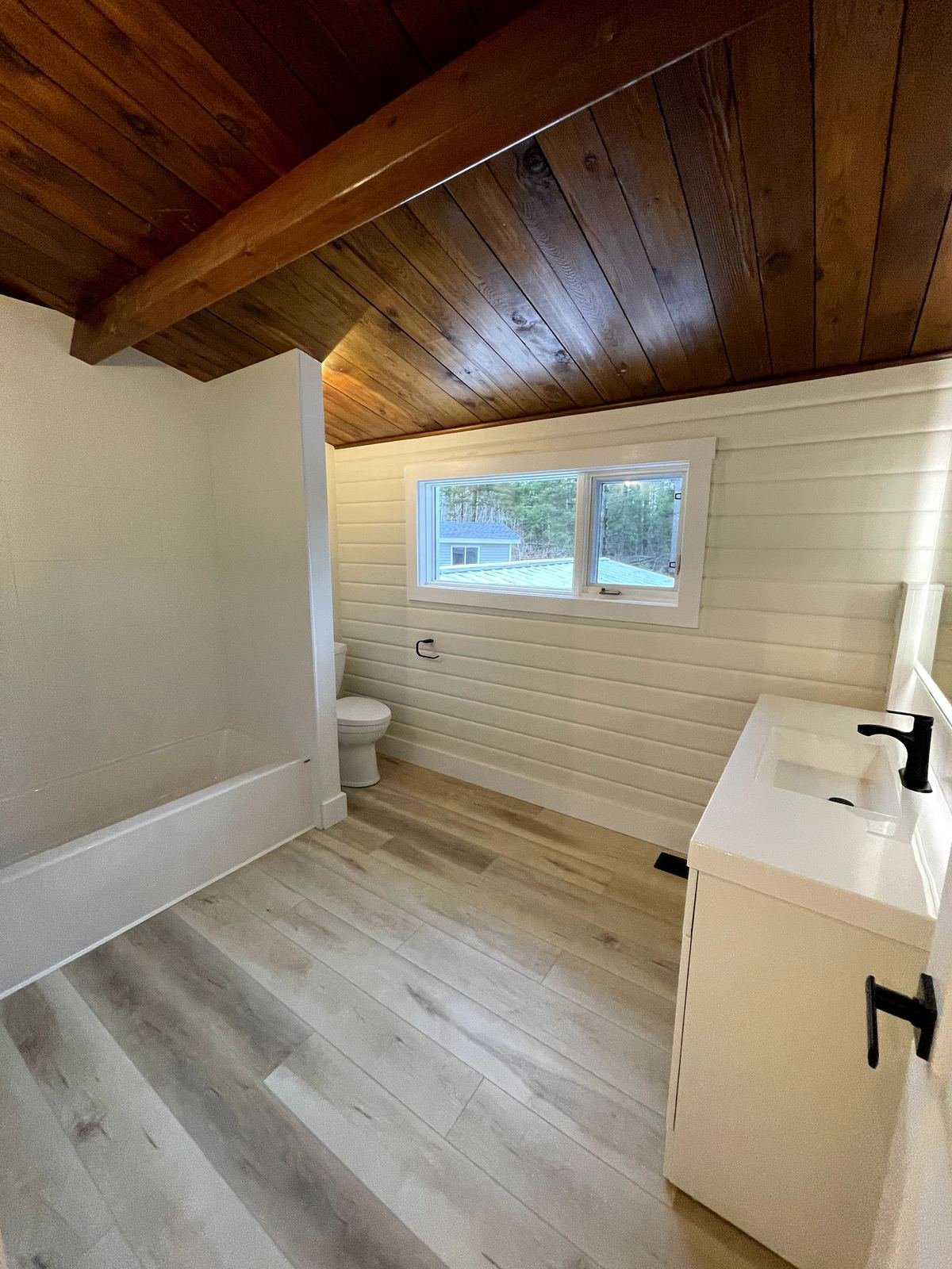 Finished bathroom with trim, fixtures, and paint