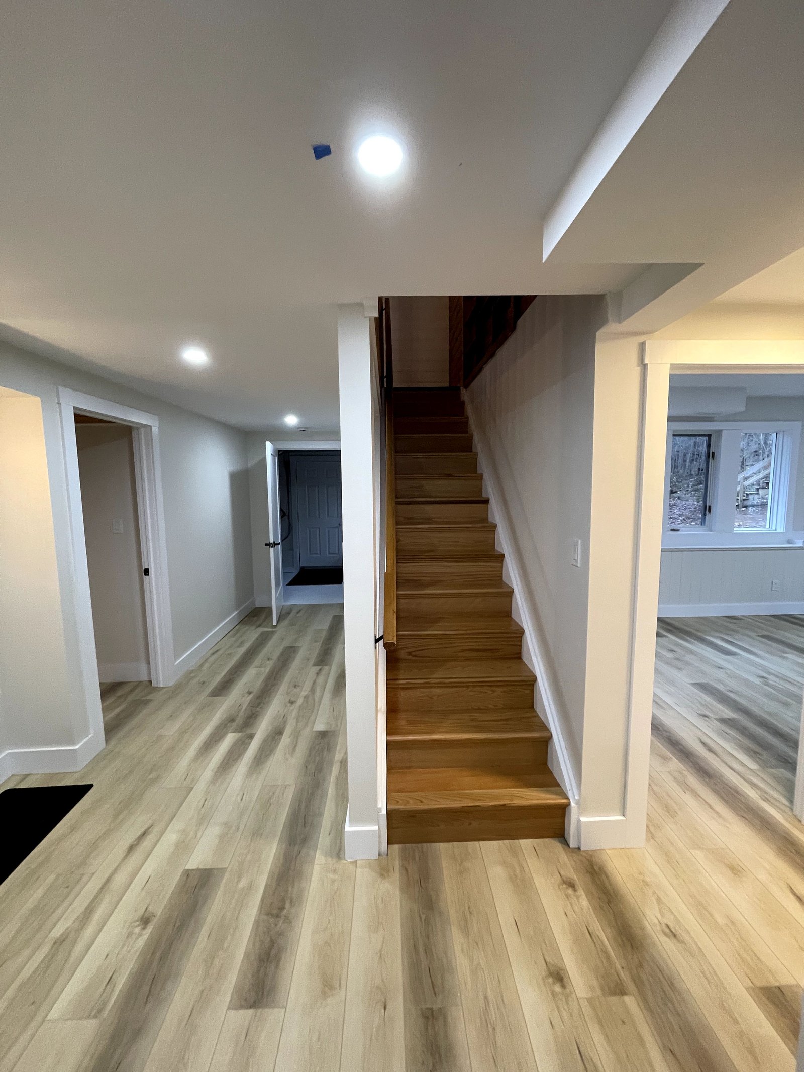 Finished basement hallway and staircase with custom trim, built by First Rate Handyman Services